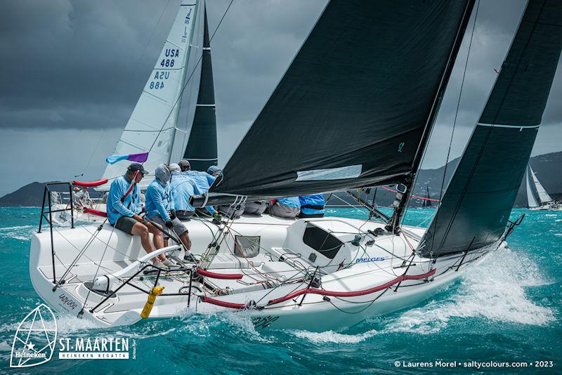 A dark sky consumed the fleet as they tacked through Marigot Bay, but all competitors held fast with full mains in over 20 kts of breeze - St. Maarten Heineken Regatta day 3 - photo © Laurens Morel / www.saltycolours.com