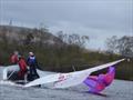 Ian & Lochlyn capsize during the 2026 Miracle Northern Area Championship & Miracle Youth & Junior National Championships at Delph Sailing Club &copy; Poppy Haslam