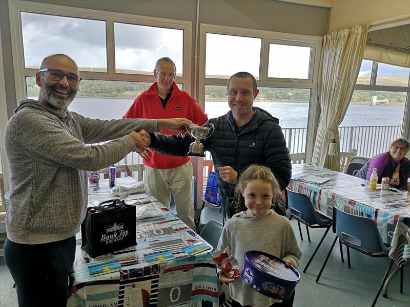 Simon & Lucy Evans receiving the spoils of victory from Delph SC's Commodore Ian Brown photo copyright Luke Harrison taken at Bolton Sailing Club and featuring the Miracle class
