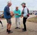 Linda Roy presenting the Timmy Roy Trophy to Dave Cooper and Jane Heath, winners of the Overy Staithe Sailing Club Mirror Open &copy; Bernard Clark and Ellie Clark