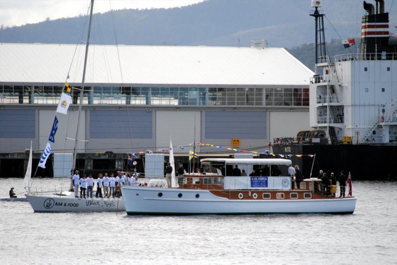 Black Magic, skippered by Graeme Mansfield, Commodore of Bellerive Yacht Club,  leads the fleet past Egeria,  with the Tasmanian Governor, Professor Kate Warner taking the salute - photo © Peter Campbell