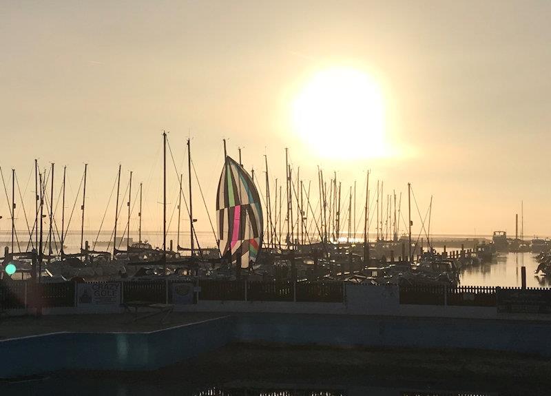 Sun through the mist and flat sea in Lymington photo copyright Robin Milledge taken at Lymington Town Sailing Club