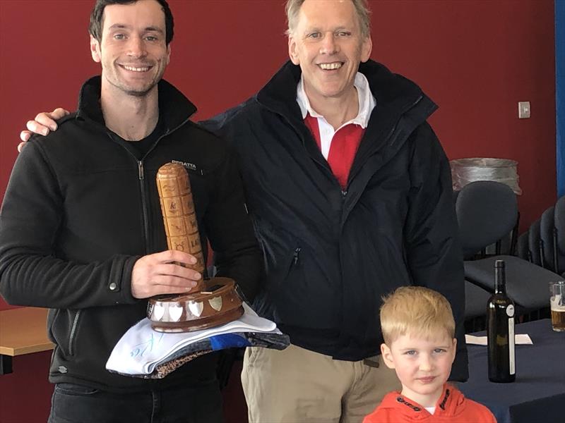 Draycote Water SC Pursuit race winner, Harry McVicar, receives the John Siggers Trophy from John Siggers himself, with John's grandson looking on photo copyright Ian Macwhinnie taken at Draycote Water Sailing Club