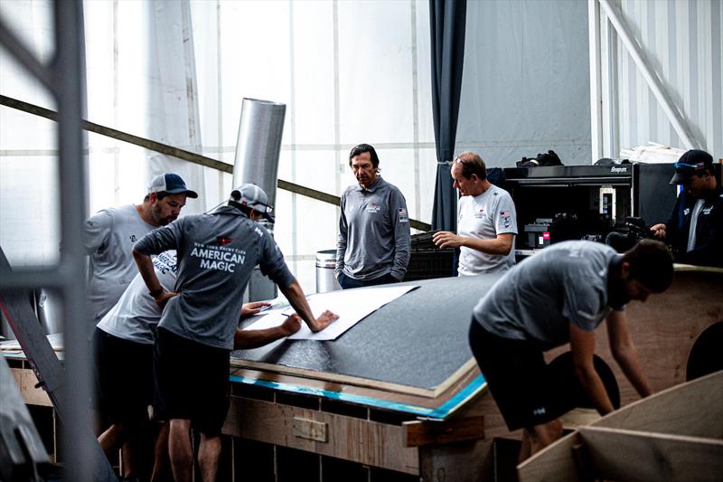 Design team members and boatbuilders prepare the replacement hull panel for installation photo copyright Sailing Energy / American Magic taken at 