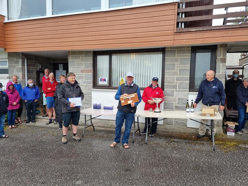 Solway Yacht Club June Open Prize-giving in the rain! John Greenwood awarded the Finn Scottish Championship, presented by Solway YC’s Finn representative Stewart Mitchell (left) with Robert Dinwiddie (Solway YC Commodore, red jacket, right) photo copyright Richard Bishop  taken at Solway Yacht Club