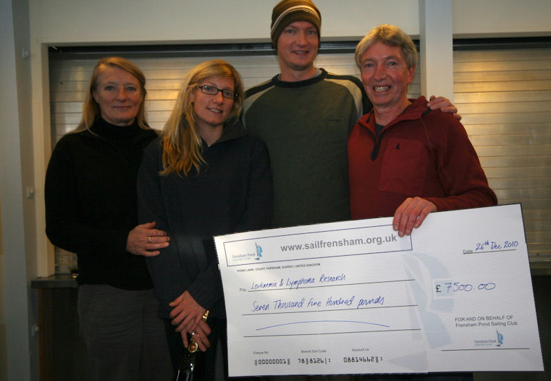 Ian Johnson(right), former club treasurer and Enterprise sailor, with his family receiving the cheque for Leukaemia Research during the Frensham Pond Sailing Club prize giving photo copyright Jim Morley taken at Frensham Pond Sailing Club