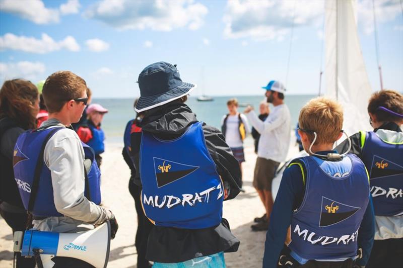 The Mudratz sailors gather around their coach to make plans for the day before racing - photo © Kerry Schutz Photography