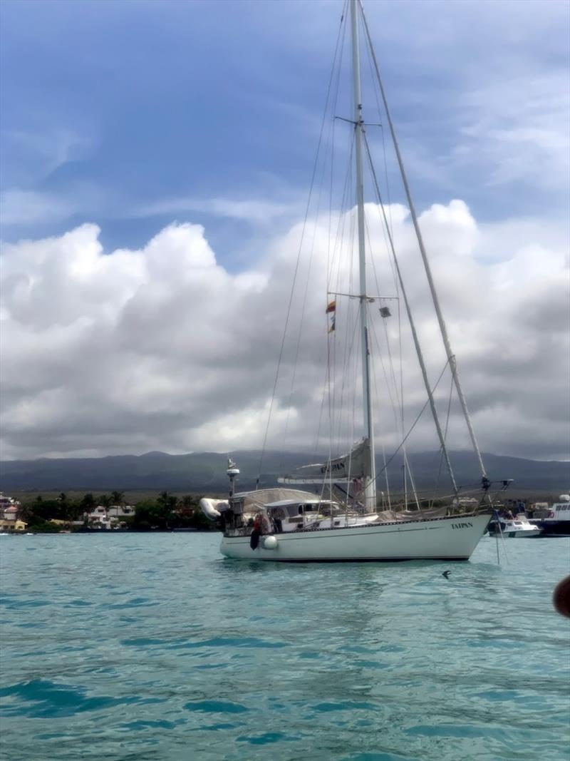 Taipan on anchor at Santa Cruz, Puerto Ayora. The swell is constant and the wind heads us into it but when the wind drops. We roll!! photo copyright SV Taipan taken at 