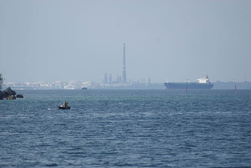 Fishing boat and cargo ships at the entrance to Cienfuegos lagoon - photo © Mission Ocean