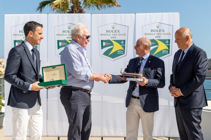 Royal Malta Yacht Club Commodore Godwin Zammit, presenting Rambler 88 Owner/ Skipper George David with the Line Honours Trophy - 2019 Rolex Middle Sea Race, day 4 photo copyright Kurt Arrigo / Rolex taken at Royal Malta Yacht Club