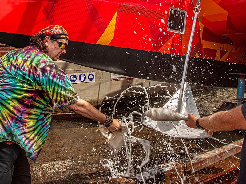 The new owner of `Vingilote` breaks the ceremonial bottle of champagne just prior to the launch of the boat. - photo © Balance Catamarans