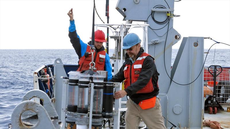 Marine chemist Ken Buesseler (right) deploys a sediment trap from the research vessel Roger Revelle during a 2018 expedition in the Gulf of Alaska. Buesseler's research focuses on how carbon moves through the ocean photo copyright Alyssa Santoro, Woods Hole Oceanographic Institution taken at 