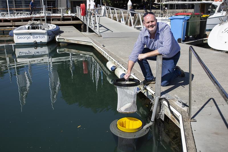 Commodore Paul Billingham with one of the newly installed SeaBins located in the CYCA Marina.  - photo © Cruising Yacht Club of Australia