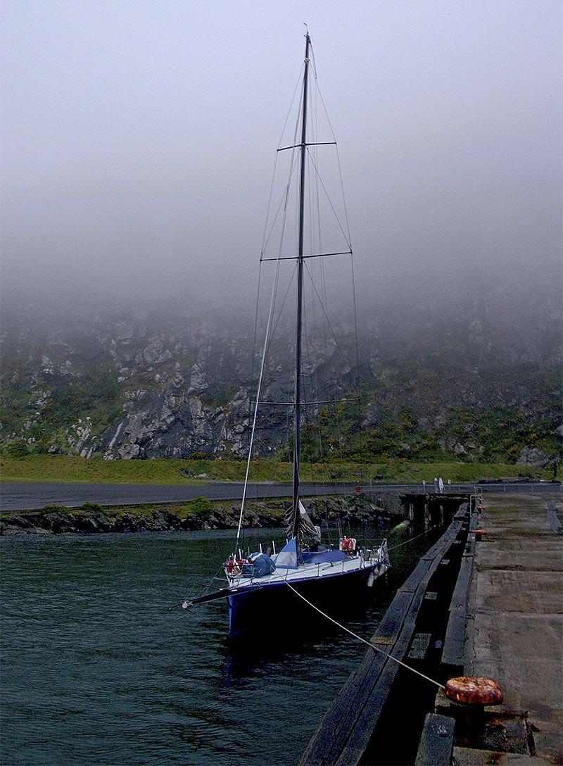 The Open 66 Gusto sits below Stanley's famous basalt massif, The Nut (and plenty of fog). - photo © John Curnow