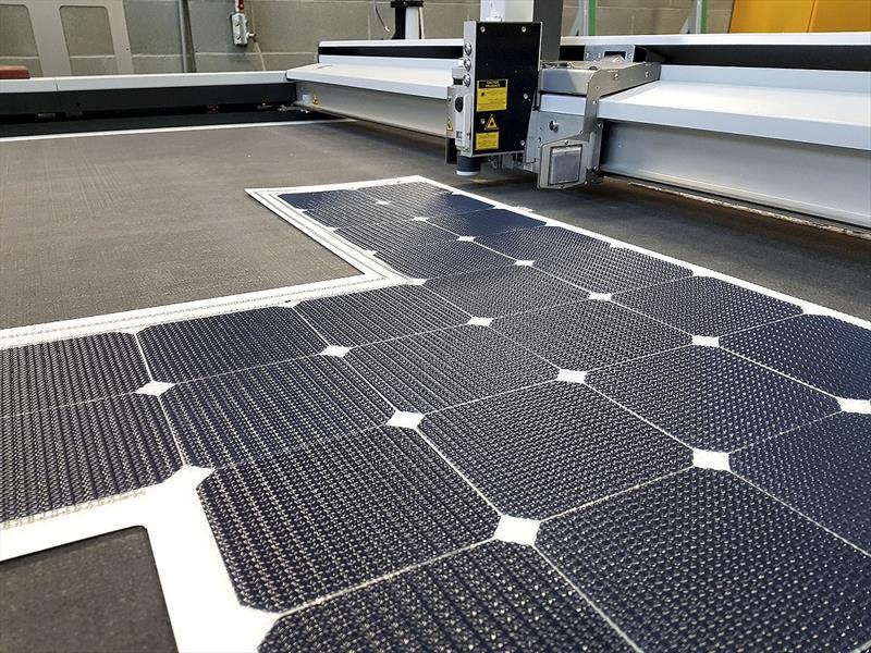 A photovoltaic module customized for the nautical market being trimmed by a computer numerical control (CNC) router - photo © Milena Milani