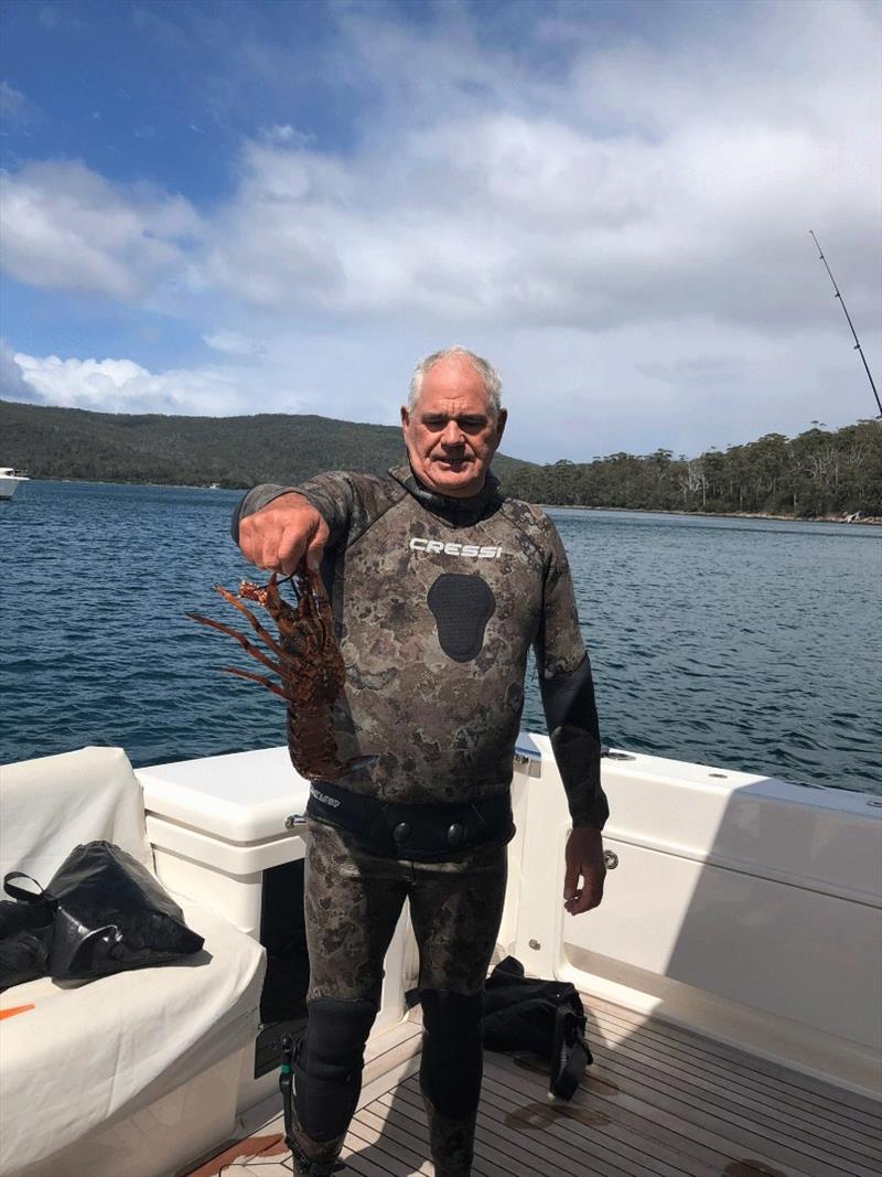 Skipper-cum-diver David Prior with some of the local natural bounty he caught, a fresh Tasmanian lobster photo copyright Riviera Australia taken at 