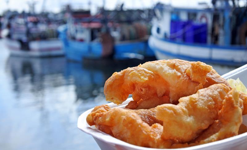 Great Australian fish and chip being eaten at Sydney Fish Markets with Australian commercial fishing boats in the background photo copyright Jessica McInerney taken at 