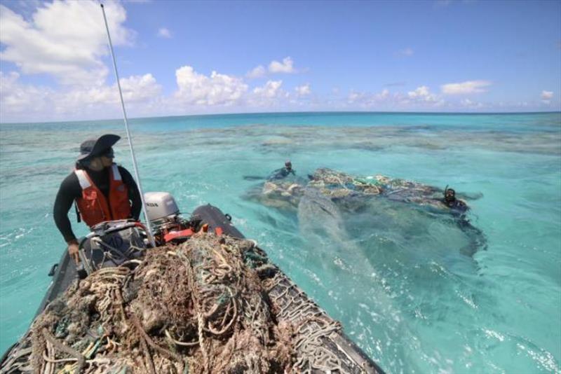NOAA Coxswain William Reich and divers Rebecca Weible and Alika Garcia survey and find a large derelict fishing net at Kamokukamohoalii (Maro Reef) photo copyright NOAA Fisheries / James Morioka taken at 