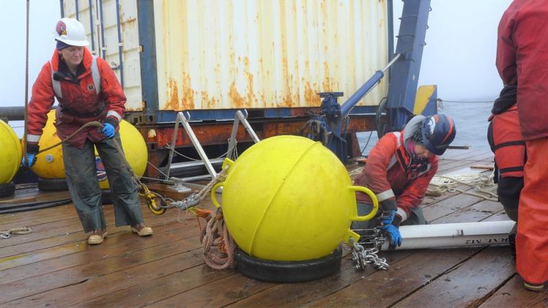 NOAA Fisheries scientists Jessica Crance (left) and Stephanie Grassia assemble mooring equipment for deployment in the Bering Sea. The acoustic recorder is in the white tube photo copyright NOAA Fisheries taken at 