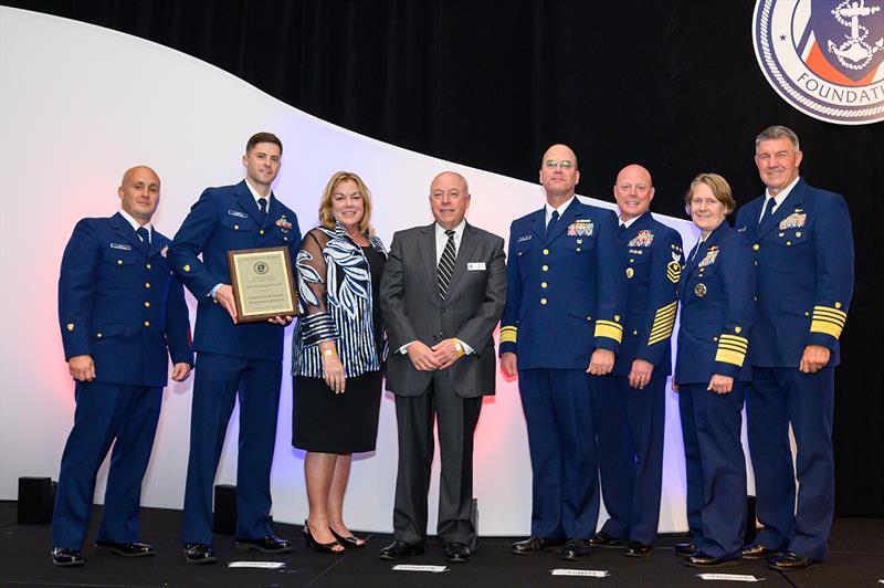 Second Class Boatswain's Mate David Reynolds, Coast Guard Chief Aviation Survival Technician Kevin Cleary (left) accepts an award from Coast Guard Foundation President Susan Ludwig and Chairman Tom Allegretti photo copyright Steven David Johnson taken at 