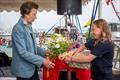 HRH The Princess Royal is presented with flowers and gifts by young RLymYC member Ruby Coster © Sportography