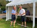 Scott Train (SYC Commodore) presents Gareth Jones (Kippford RNLI Operations Manager) with a substantial cheque with all the entry fees from the Regatta and donations from the recent SYC Challenger open meeting © Beatrice Overend