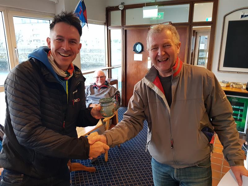 Brendan Foley (L) gets his Frostbite Mug from Neil Colin (R) on Dun Laoghaire Frostbite Series 2 Day 5 photo copyright Frank Miller taken at Dun Laoghaire Motor Yacht Club