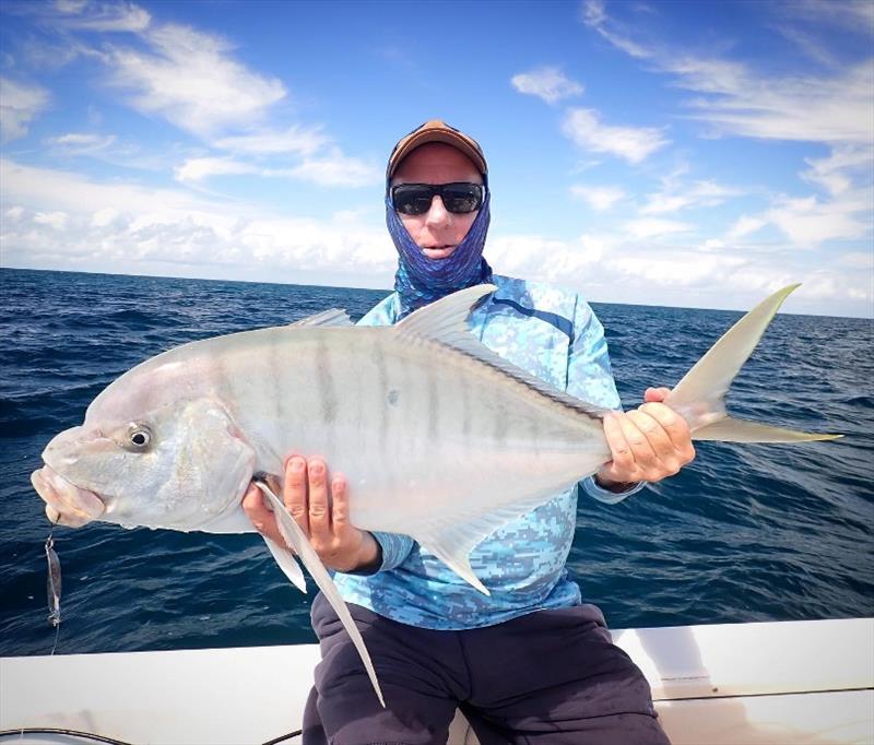 Paul with a solid golden trevally caught using a metal twisty with Tri from Fraser Guided Fishing photo copyright Fraser Guided Fishing taken at 