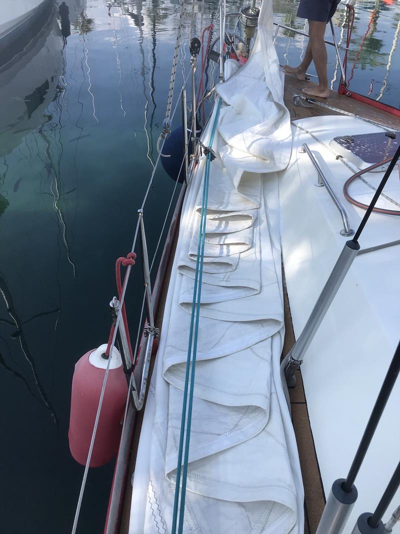 Removing and folding sails for winter - photo © SV Red Roo