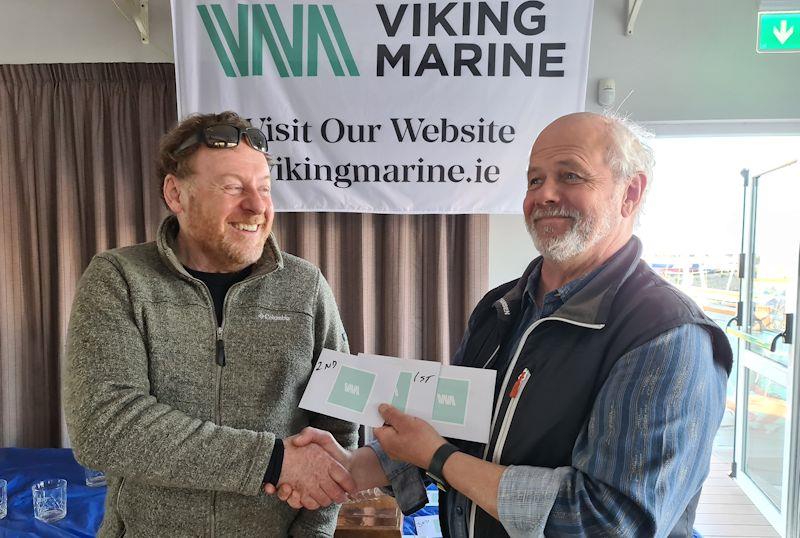 Conor O’Leary collecting overall prizes for other members of the ILCA 7 fleet from sponsor Ian O’Meara - Viking Marine Frostbite Series prize-giving at Dun Laoghaire photo copyright Frank Miller taken at Dun Laoghaire Motor Yacht Club