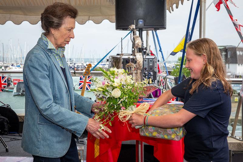 HRH The Princess Royal is presented with flowers and gifts by young RLymYC member Ruby Coster - photo © Sportography