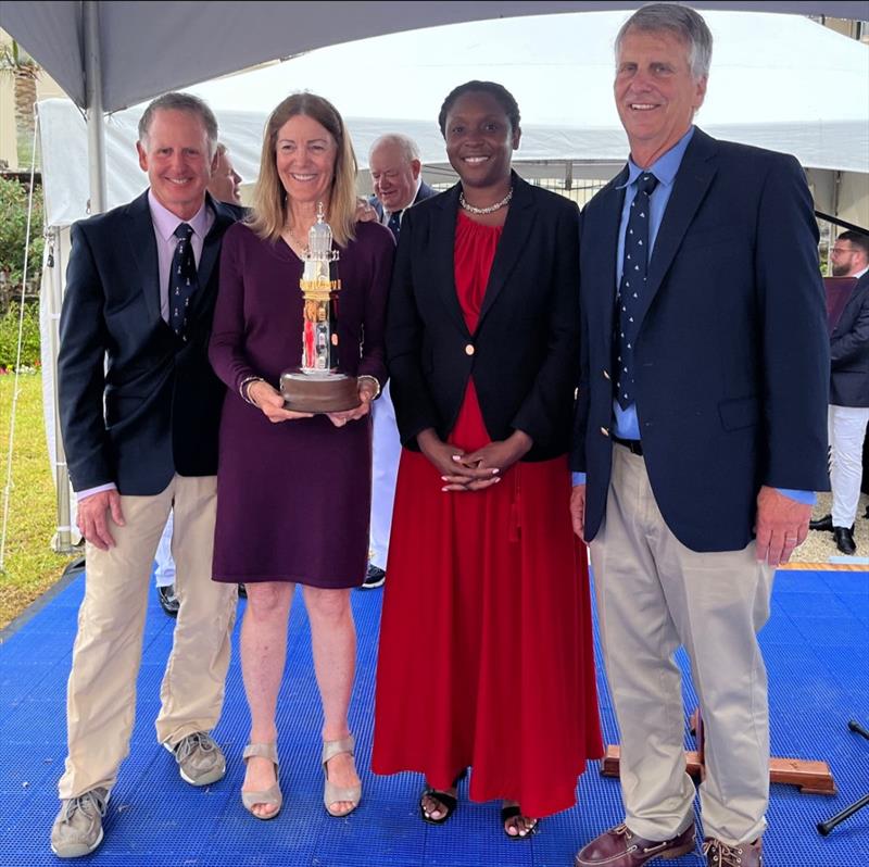 Her Excellency, the Governor of Bermuda, Ms. Rena Lalgie (red dress) presents the St. David's Lighthouse Trophy to the Illusion crew (left to right) Jonathan Livingston, Sally Honey, Stan Honey. photo copyright Trixie Wadson taken at Royal Bermuda Yacht Club