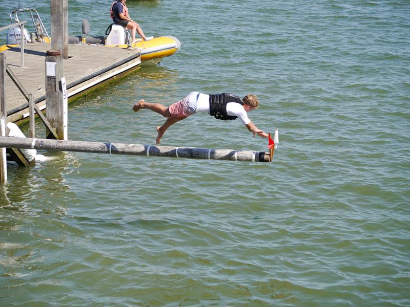 Charlie Dixon getting the flags on the greasy pole during Regatta Day