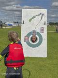The Commodore being water bombed by a youngster during the NCSC August Bank Holiday Games 2023 © Katheryn Hinsliff-Smith