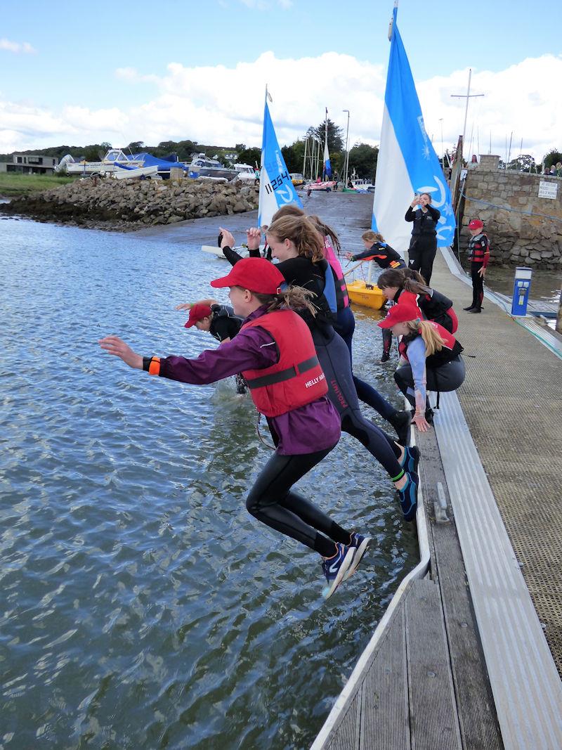 Solway YC Cadet Week - Airborne before the splash; cadets having fun! photo copyright Becky Davison taken at Solway Yacht Club