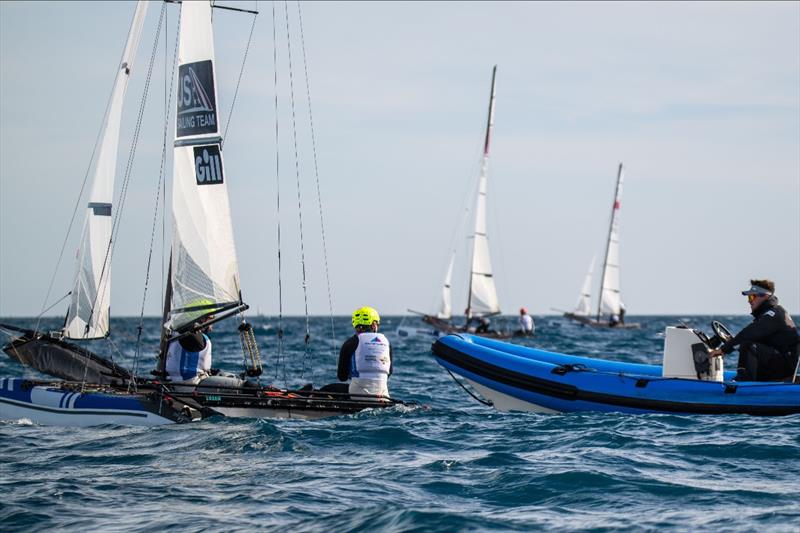 US Sailing Team's Sarah Newberry Moore and David Liebenberg check in with USST Nacra 17 Coach Tom Zajac between races on their last day of the Trofeo Princesa Sofía - photo © US Sailing Team