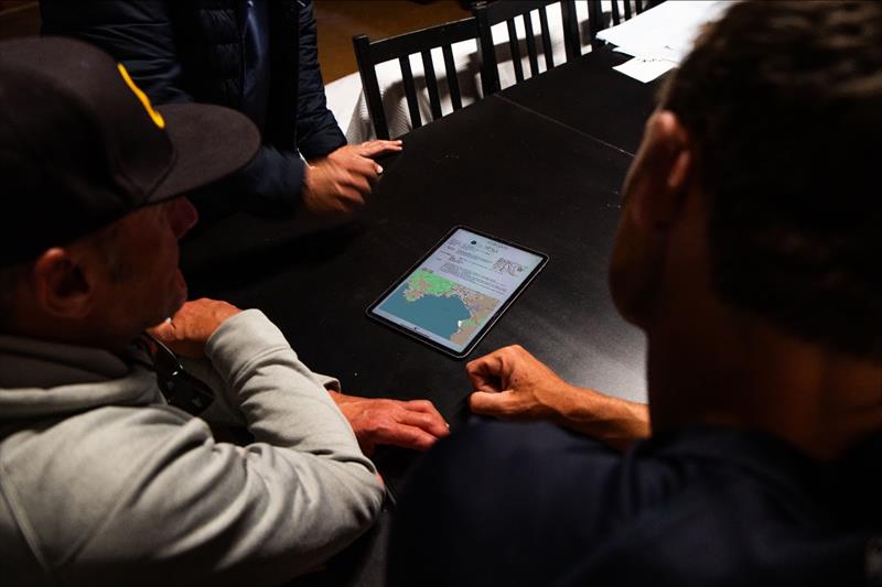 Erik Bowers (USST ILCA 6 Coach), Ryan Minth (USST ILCA 7 Coach), and Robby Bisi (USST Mixed 470 Coach) gather around the day's forecast photo copyright US Sailing Team taken at Real Club Náutico de Palma