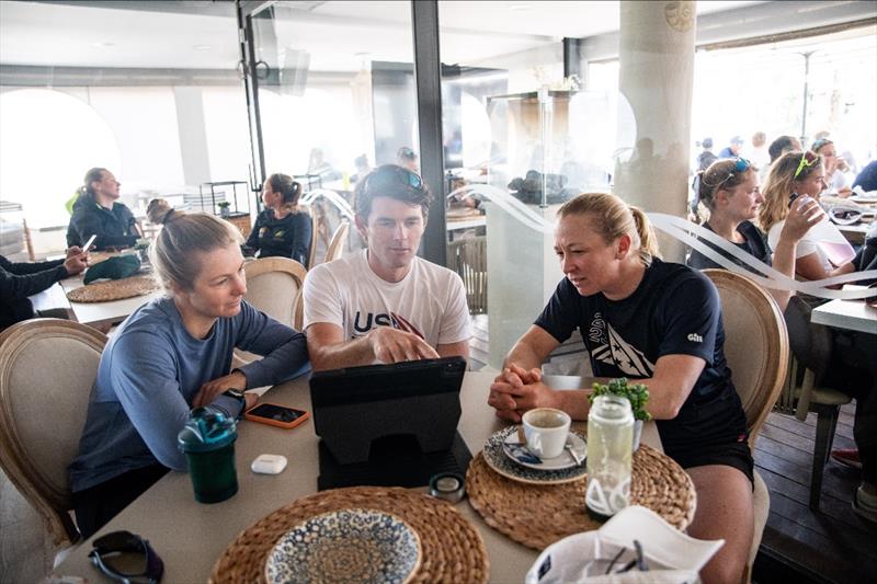 Stephanie Roble and Maggie Shea meet before racing with USST 49erFX Coach Evan Aras in the cafe near the 49erFX boat park photo copyright US Sailing Team taken at Real Club Náutico de Palma
