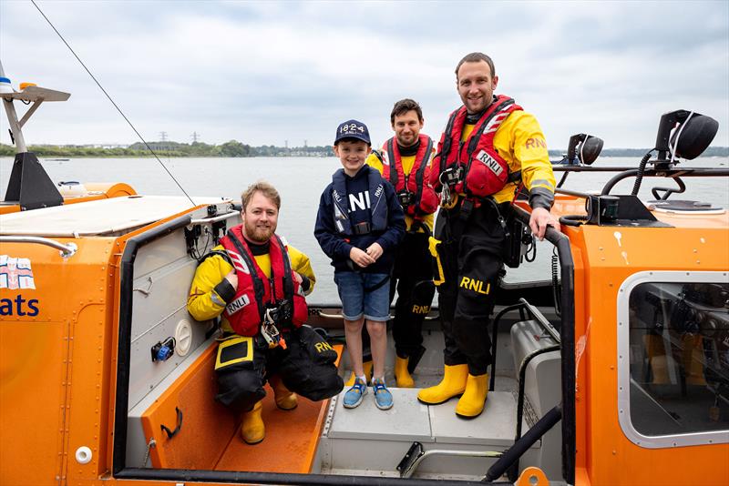 Young supporter Barnaby steps aboard an inshore rescue hovercraft - photo © RNLI / Nathan Williams