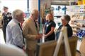 His Majesty being introduced to two shop volunteers by Lifeboat Operations Manager Denis Brophy