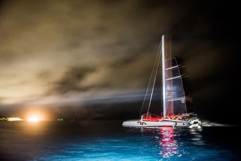 After finishing, Argo rolls up her jib with St. George's Harbour in the background and begins motor-sailing slowly around the island to Hamilton.  - photo © Chris Burville