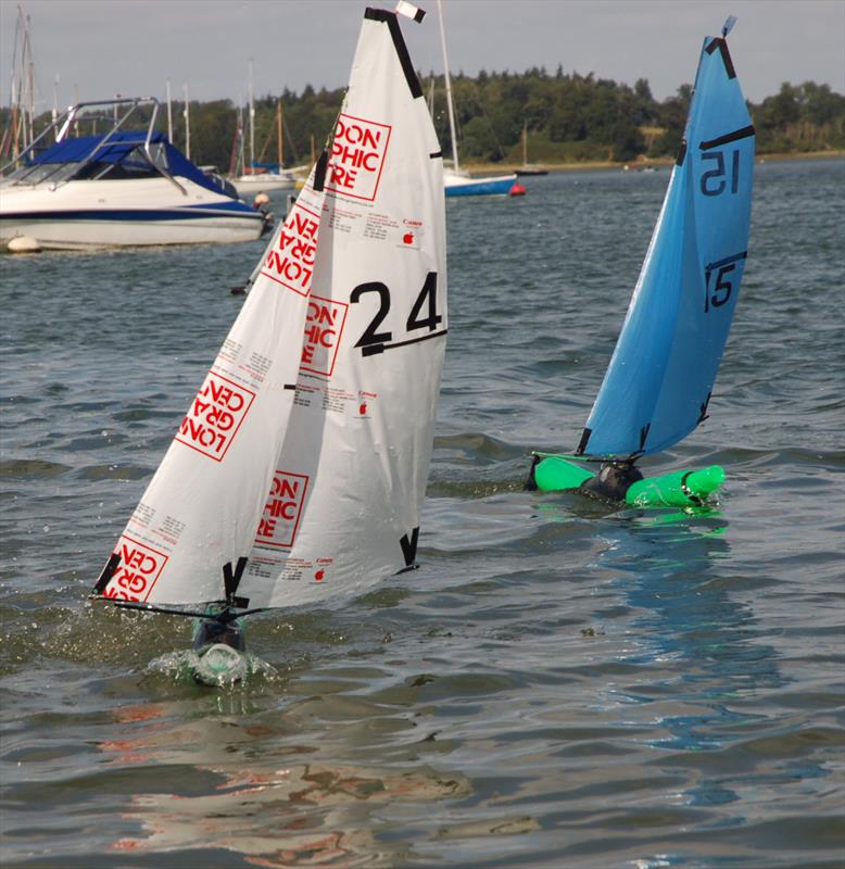 Mike Pert (24) runs away from CJ Vice (15) during the 2015 Bottle Boat Championship at Waldringfield photo copyright Roger Stollery taken at Waldringfield Sailing Club and featuring the Model Yachting class