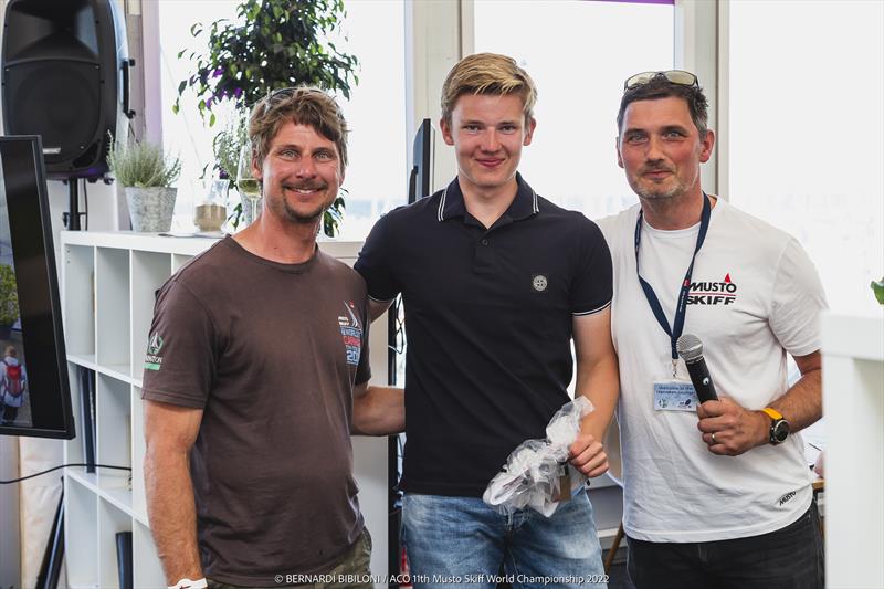 11th ACO Musto Skiff World Championship at Kiel Week Gala Dinner - Eddie Salleicken (centre) photo copyright Bernardí Bibiloni / www.bernardibibiloni.com taken at Kieler Yacht Club and featuring the Musto Skiff class