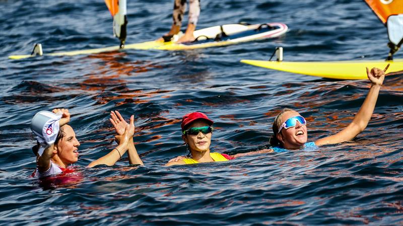 The three RS:X Womans Medal winners celebrate soon nafter the race finish - Tokyo2020 - Day 7- July, 31, - Enoshima, Japan photo copyright Richard Gladwell / Sail-World.com / nz taken at  and featuring the RS:X class