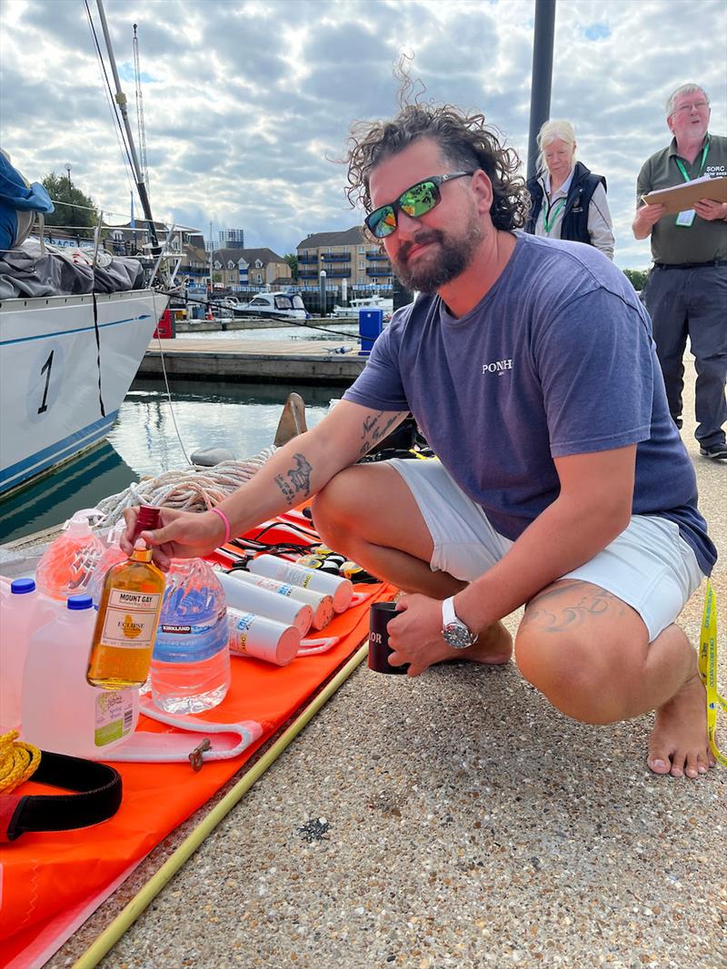 Skipper Taylor Grieger of Godspeed USA (01) introduces some “traditional” military persuasion to the proceedings – sadly to no avail. Turns out the inspectors are tea drinkers. No doubt the rum was taken care of later - photo © Jacqueline Kavanagh / OGR 2023