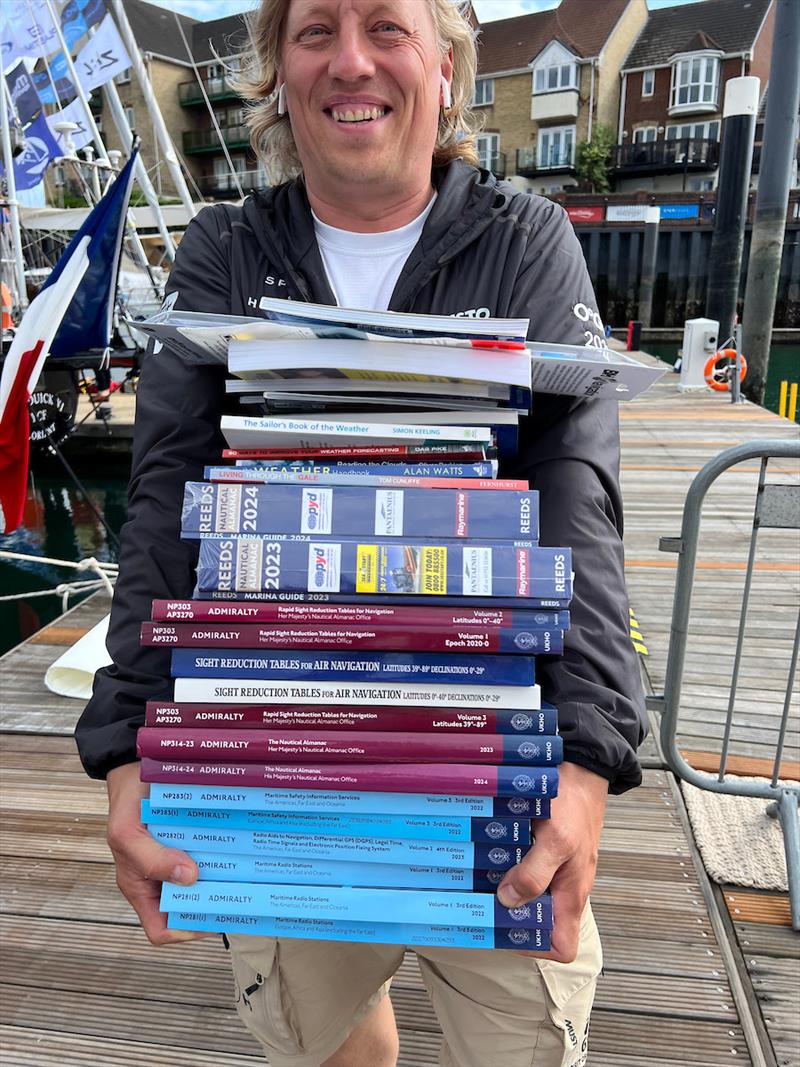 Skipper of Spirit of Helsinki FI (71) Jussi Paavoseppä stocking up on a little light reading! Racing like it's 1973 means stepping back in time, forsaking modern tech, Kindles, iPhones, Spotify in favour of sextants, paper charts, “real books”, cassette - photo © Aida Valceanu / OGR2023