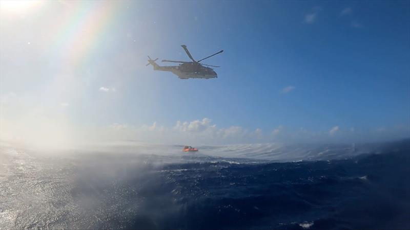 Dramatic scenes as the helicopter creates swell making the rescue of Stéphane Raguenes more challenging. Three crew members entered the liftraft to assist in the lift - photo © Margault Demasles / Team Triana / OGR