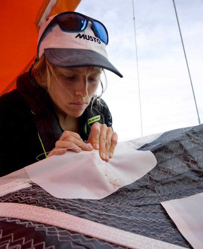 Catheryne Langford repairs a chafed area on Explorer's cruising code sail - photo © OGR2023 / Explorer