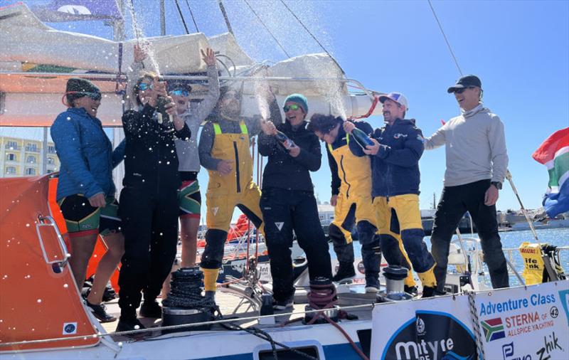A well-deserved three-bottle celebration for the overjoyed South African entrant photo copyright OGR2023 / Jacqueline Kavanagh taken at  and featuring the Ocean Globe Race class
