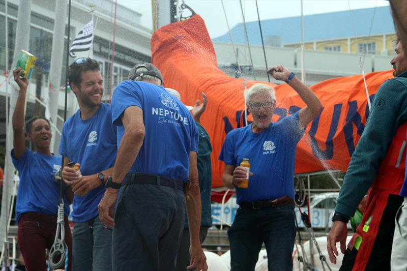 Neptune crew member Bertrand Delhom enjoying a champagne shower photo copyright OGR2023 / Marco Ausderau taken at  and featuring the Ocean Globe Race class